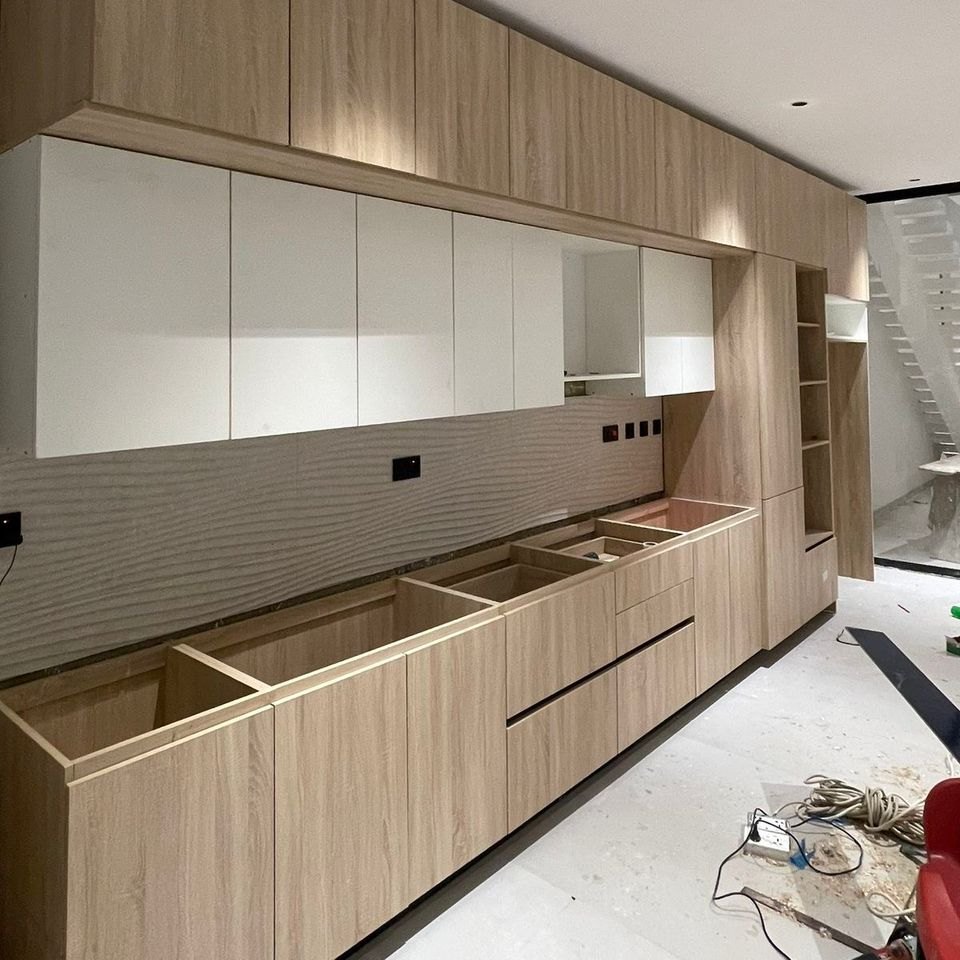 A kitchen run part way through installation, carcasses set and doors going on