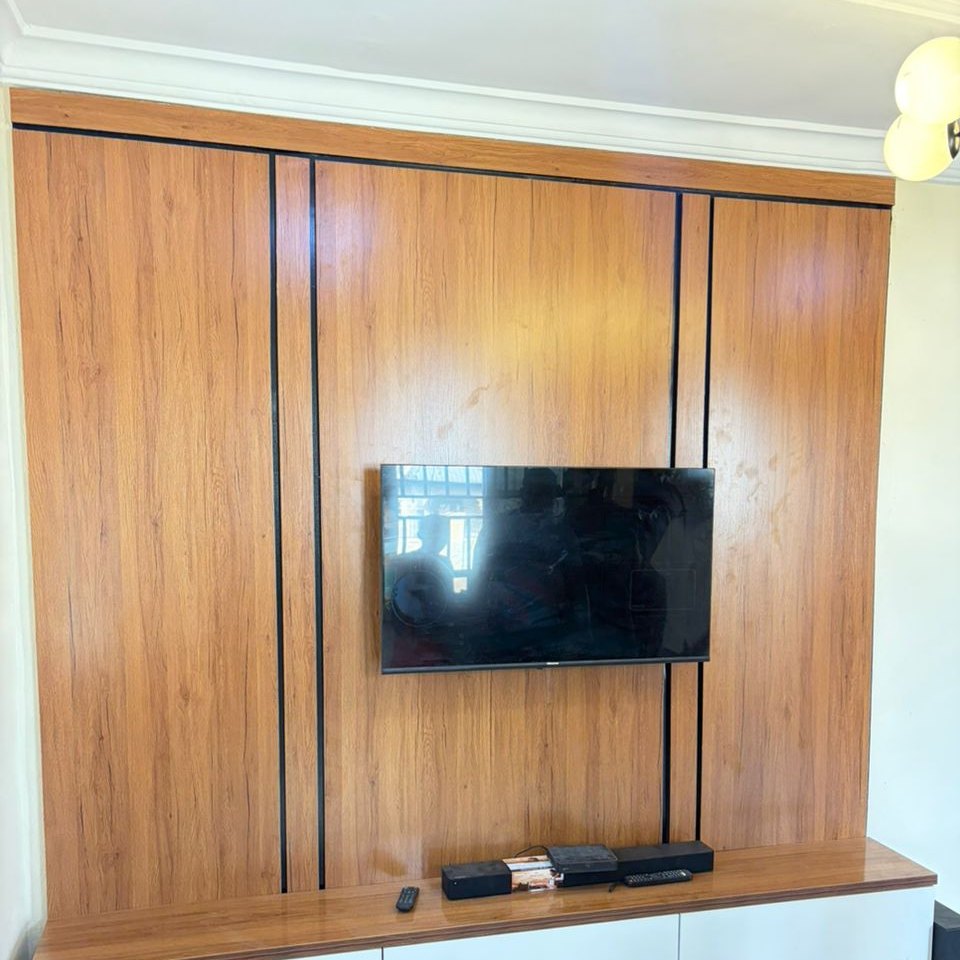 A finished walnut panelled TV wall with its floating console