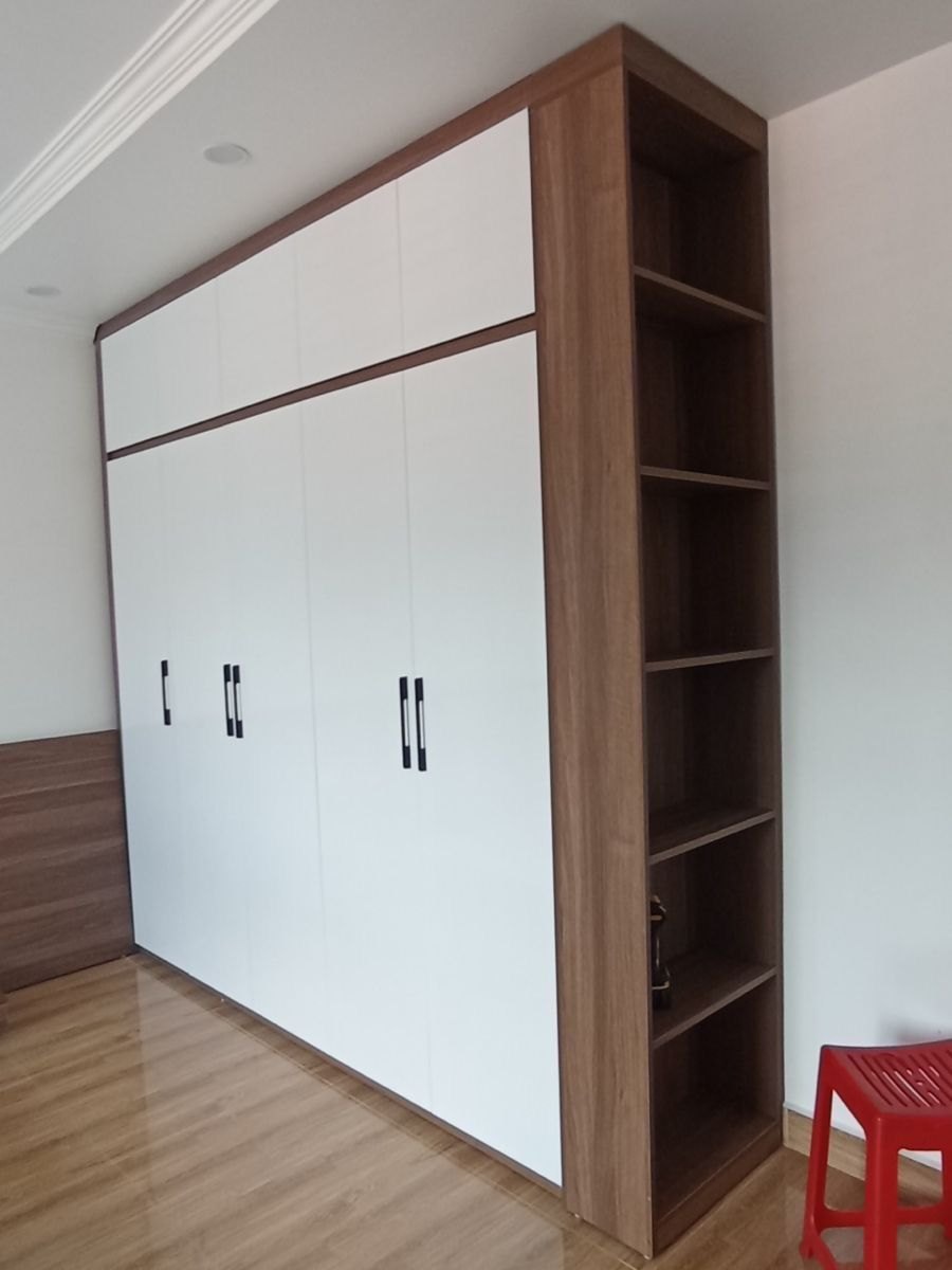 White gloss fitted wardrobe with a walnut bookcase end panel, built by Seunscope in Osogbo