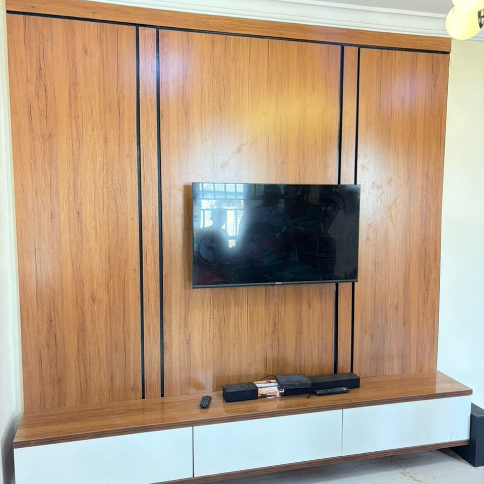 Walnut panelled TV wall with a floating console, fitted in an Osogbo living room